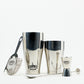 O'Donnell Moonshine Bar-Set aus Edelstahl mit Boston Shaker, Barsieb, Jigger und Barlöffel vor weißem Hintergrund.