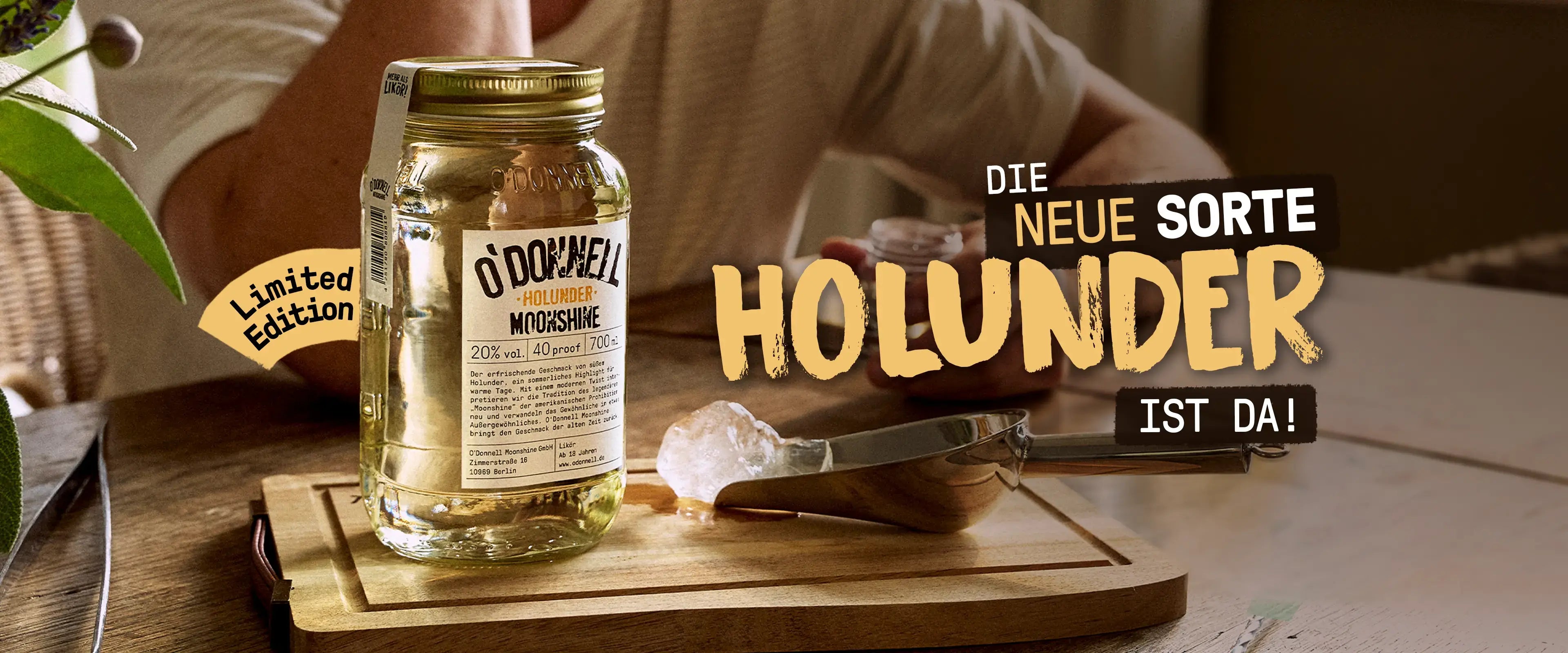 O'Donnell Moonshine Mobile LP Banner für die neue Sorte Holunder mit 700ml Mason Jar und Eisschaufel auf den branded Holzbrett.